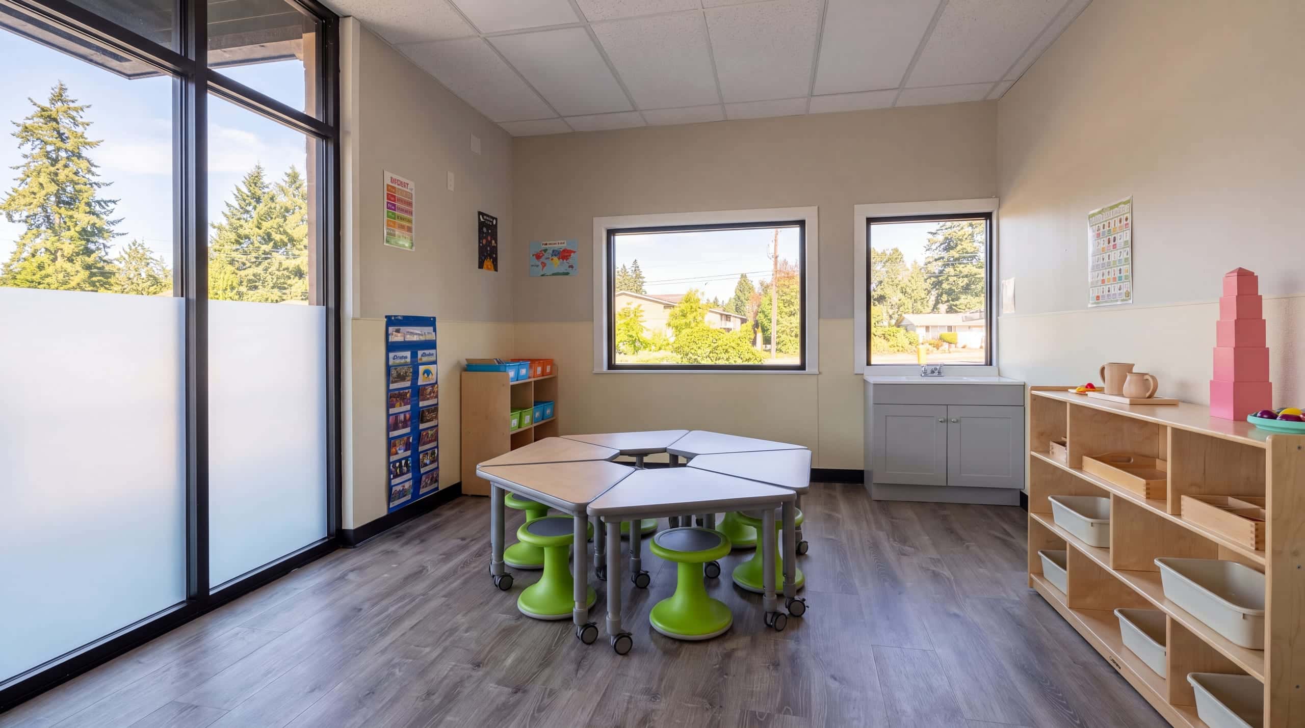 A classroom at the end of the day, stools tucked in and shelves ready